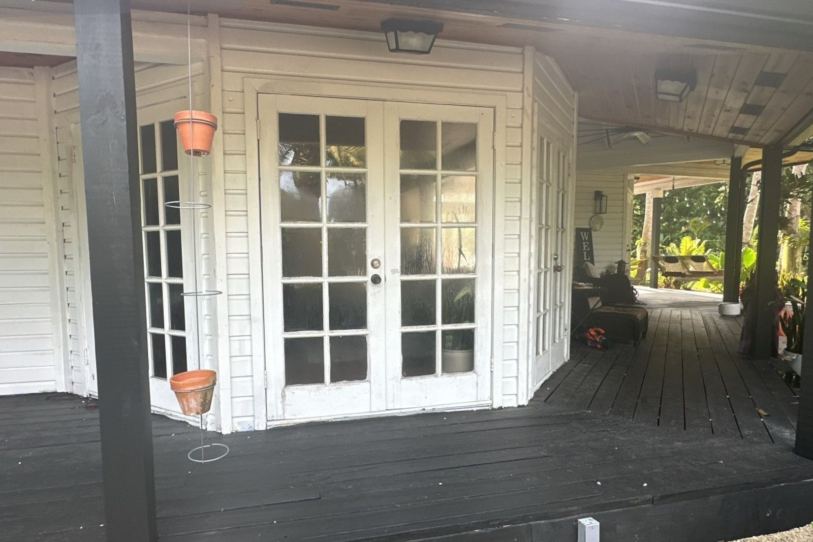 Impact French doors before installation on a covered porch in South Florida