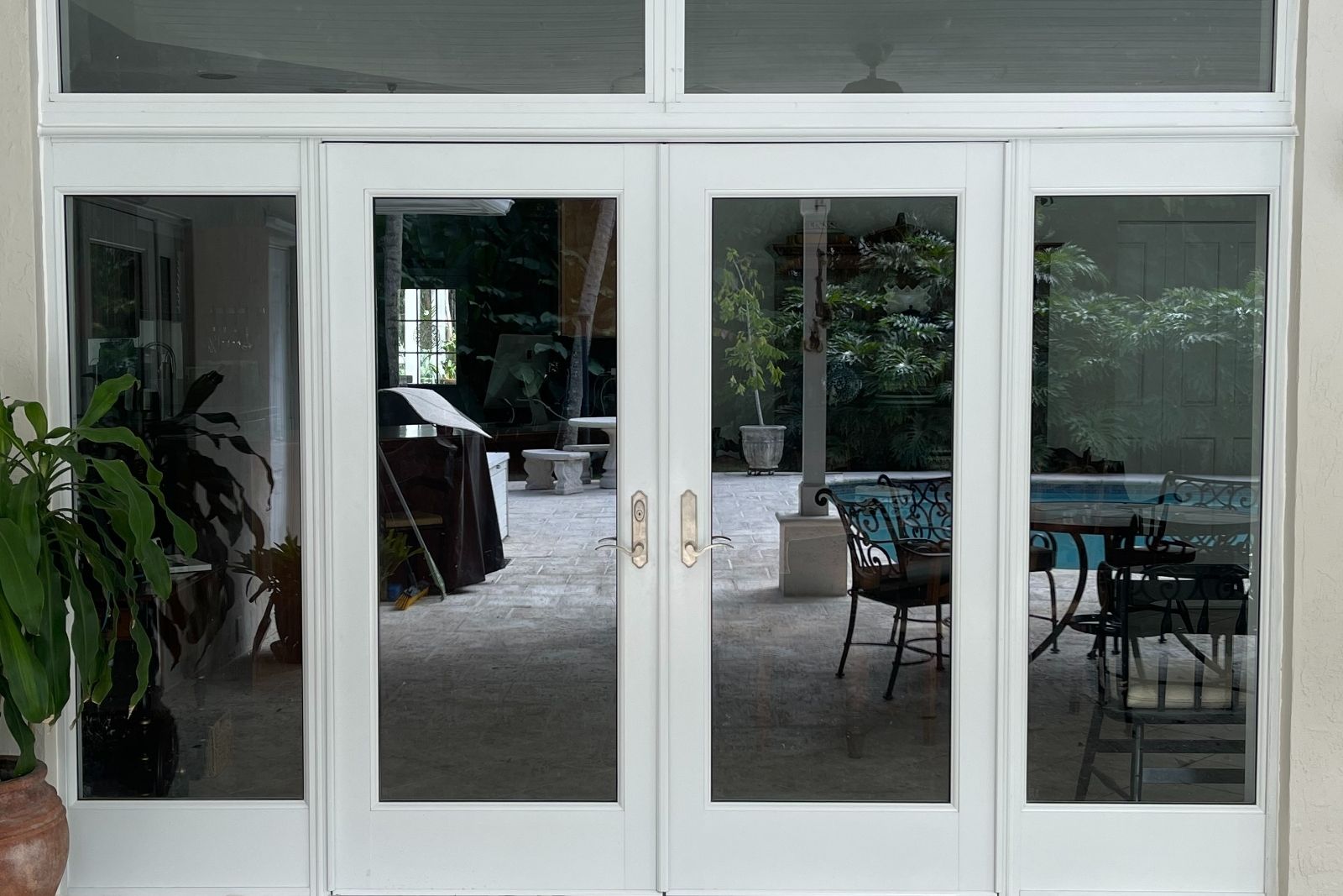 White impact door system with sidelites and transom after installation in Miami