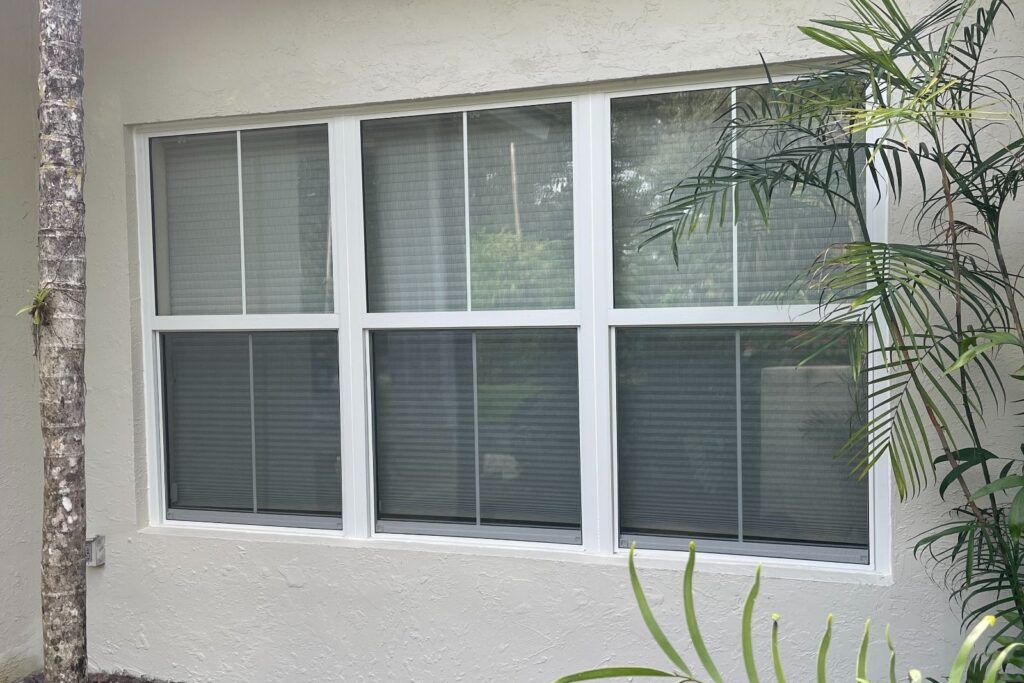 White impact window with grid pattern after installation on exterior wall in South Florida
