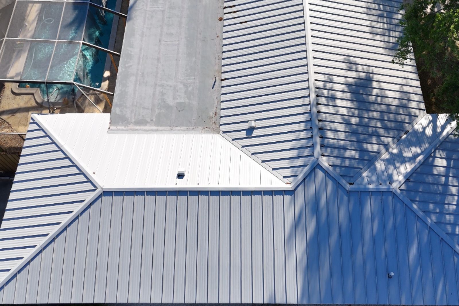 Aerial view of a white standing seam metal roof showcasing a clean finished system.