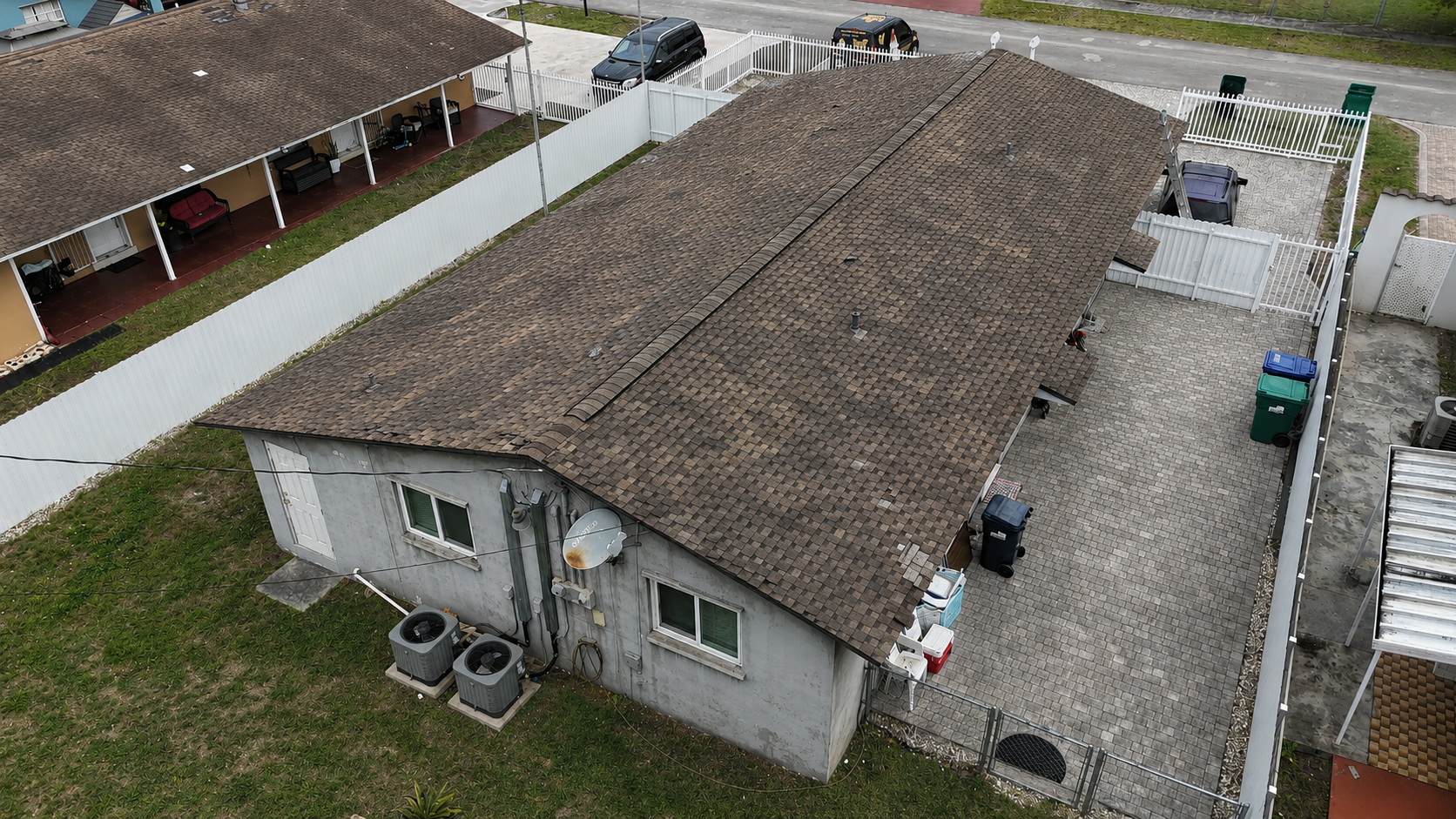 Additional aerial view of a house with an older roof