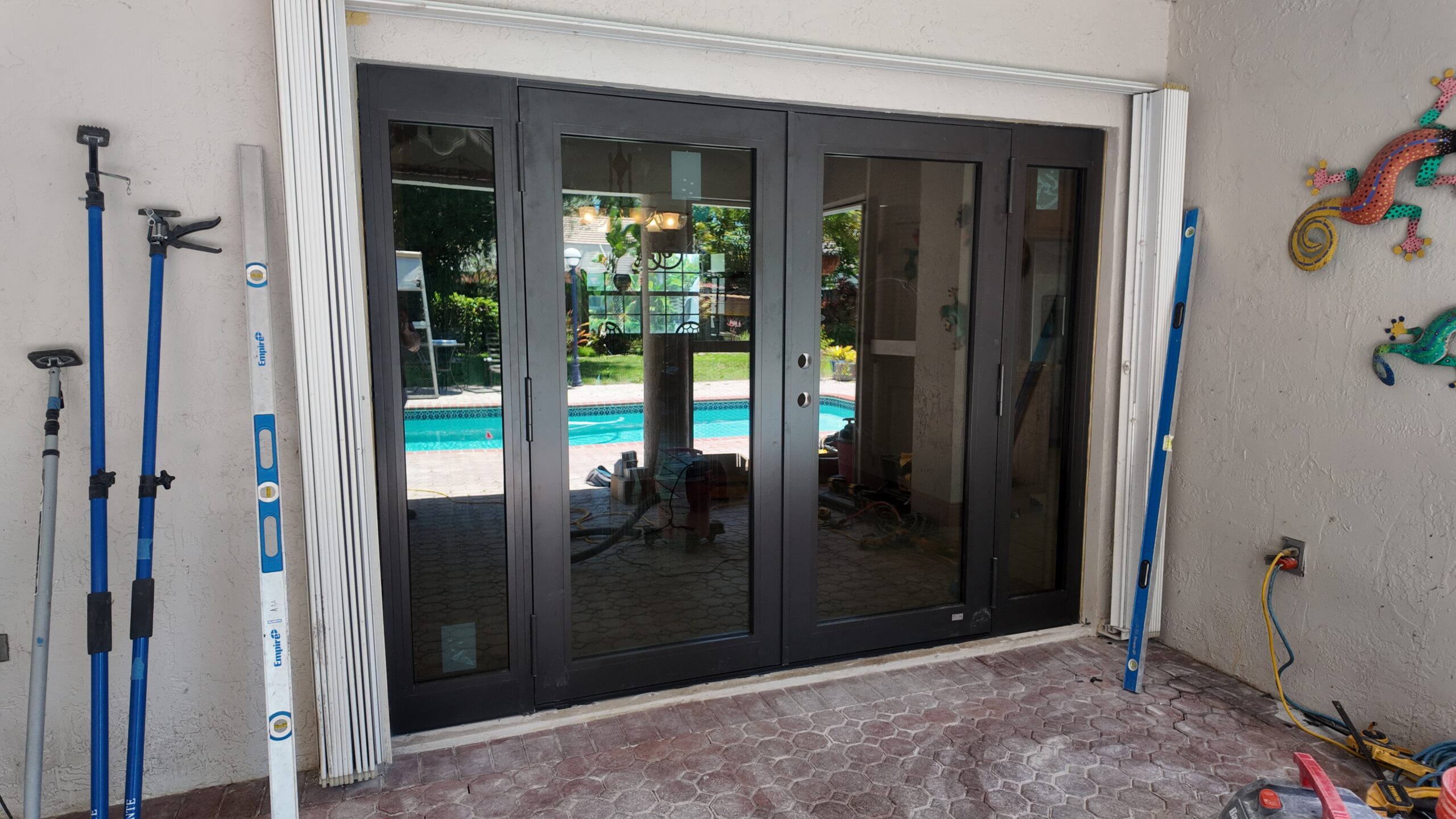 New dark-framed sliding glass doors facing the patio and pool