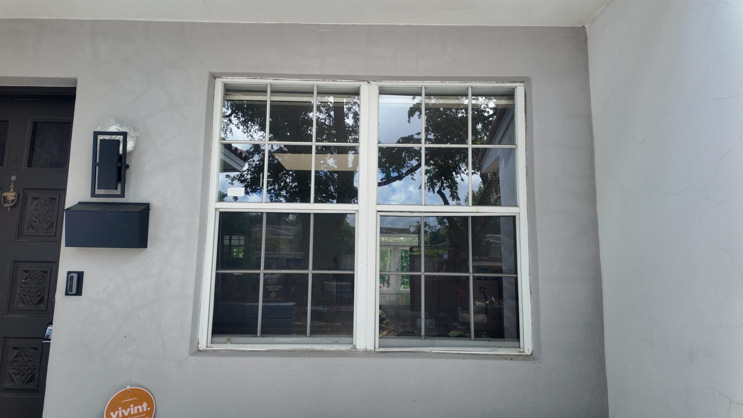 Existing light-framed windows before the Coral Gables installation