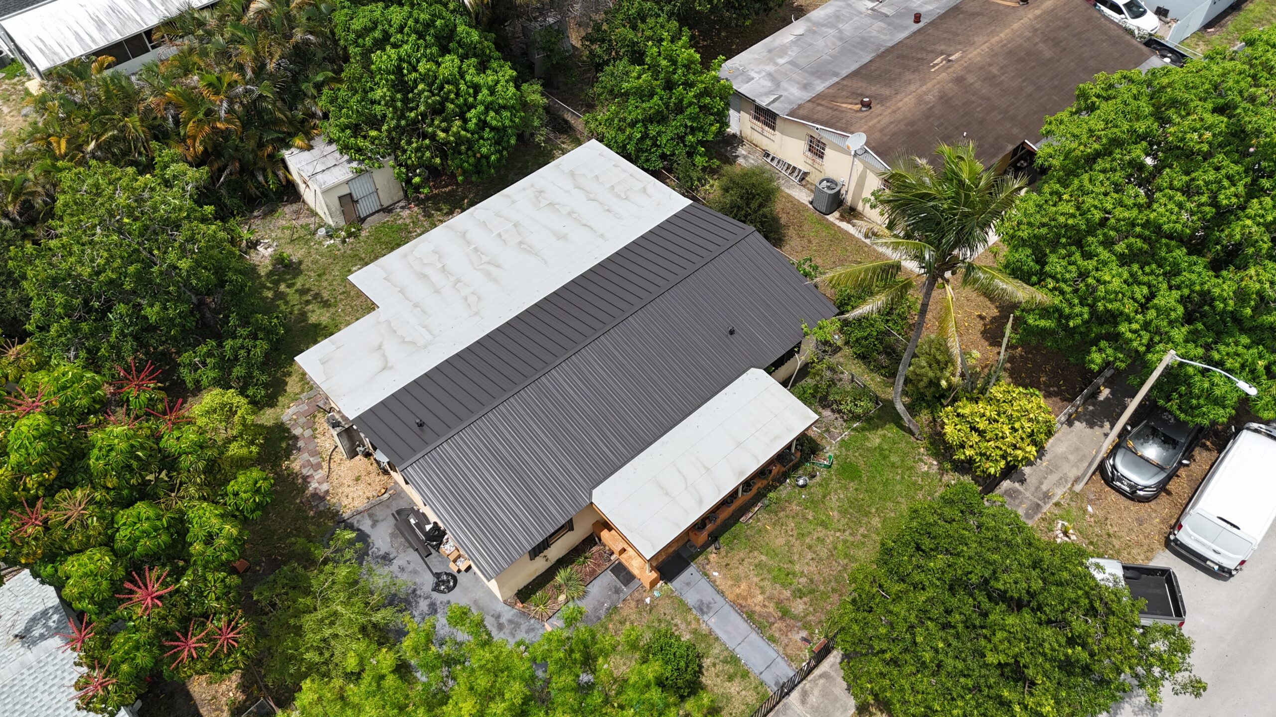 Installed standing-seam metal roof and white flat-roof sections in Miami Gardens, aerial view 3