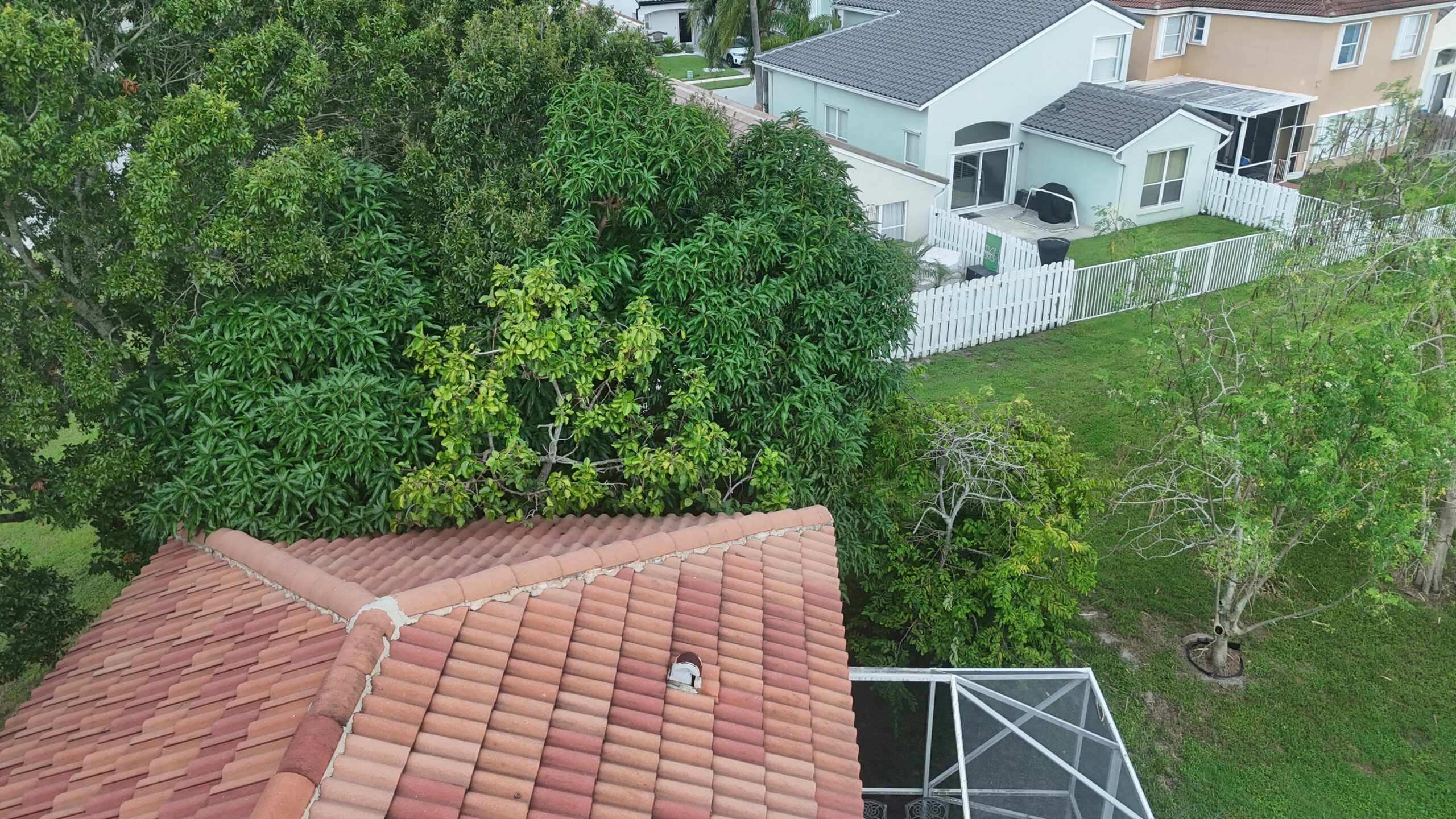 Before aerial view of the existing tile roof and connected roof sections